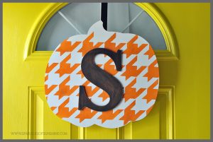 Instead of a wreath, try a hanging door sign this year. Learn how to make this easy monogrammed pumpkin door decor for fall at Sparkles of Sunshine.