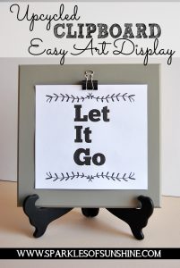 Turn an old piece of thrift store art into an upcycled clipboard easy art display piece!