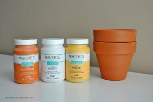 Decorate your home for fall easily with these simple DIY candy corn painted flower pots. Keep for yourself or give as a gift!