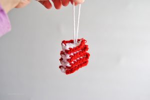 Decorate your Christmas tree with colorful old-fashioned candy ornaments. This easy crochet ribbon candy Christmas ornament free pattern and tutorial makes it simple to fill up your tree with yarn ornaments this year.