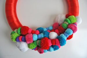 Add some color to your home this Christmas with the most wonderful, colorful pom pom holiday wreath. See the simple tutorial at Sparkles of Sunshine today.