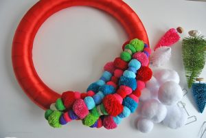 Add some color to your home this Christmas with the most wonderful, colorful pom pom holiday wreath. See the simple tutorial at Sparkles of Sunshine today.