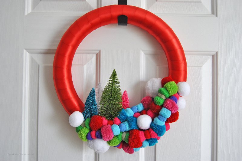 Add some color to your home this Christmas with the most wonderful, colorful pom pom holiday wreath. See the simple tutorial at Sparkles of Sunshine today.