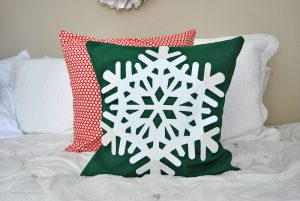 Make the easiest dollar store holiday pillow cover for just a few dollars worth of materials. It's great for decorating your home for the holidays on a budget.