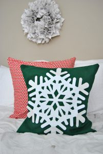 Make the easiest dollar store holiday pillow cover for just a few dollars worth of materials. It's great for decorating your home for the holidays on a budget.