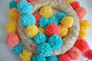 Learn how to make an easy colorful pom pom wreath for Spring, step by step at Sparkles of Sunshine.