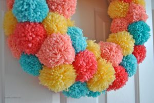 Learn how to make an easy colorful pom pom wreath for Spring, step by step at Sparkles of Sunshine.