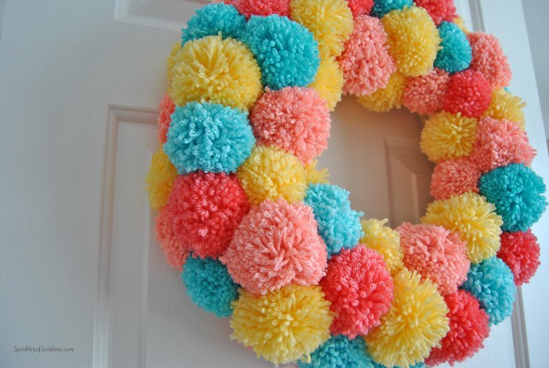 Learn how to make an easy colorful pom pom wreath for Spring, step by step at Sparkles of Sunshine.
