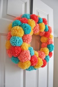 Learn how to make an easy colorful pom pom wreath for Spring, step by step at Sparkles of Sunshine.