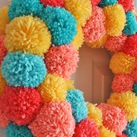 Learn how to make an easy colorful pom pom wreath for Spring, step by step at Sparkles of Sunshine.
